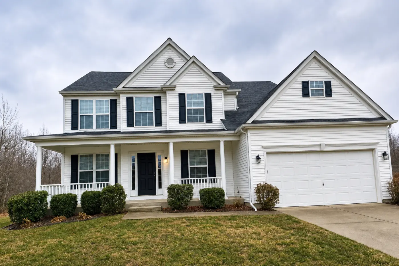 The same house after Enhance, straightened, with brighter white siding and more cloud detail, the sky still grey and overcast